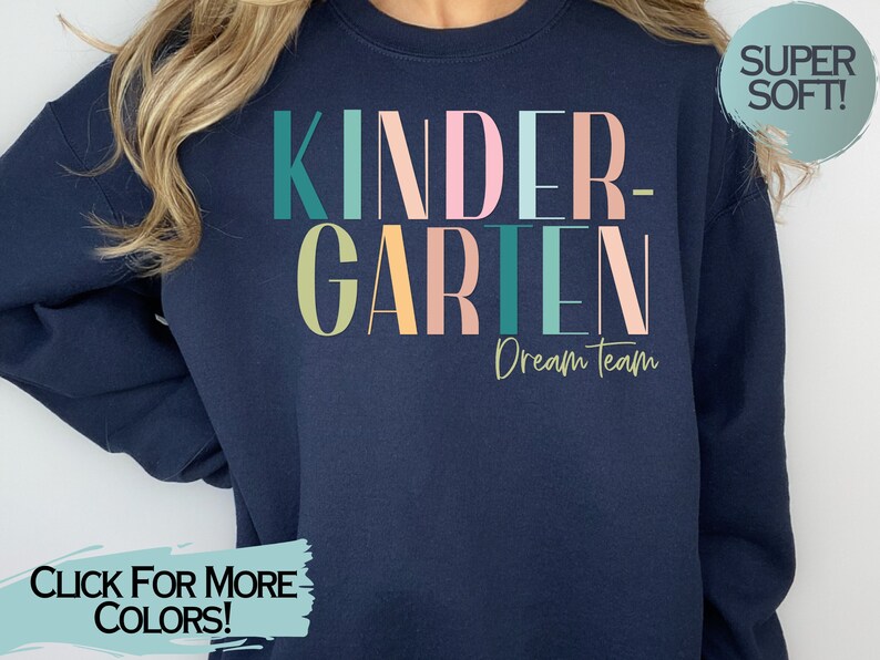 May include: A navy blue sweatshirt with the text "KINDERGARTEN Dream Team" in colorful letters. The sweatshirt is super soft.
