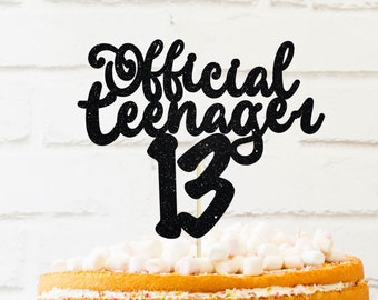 May include: Black glitter cake topper with the text "Official Teenager 13" on a white background.