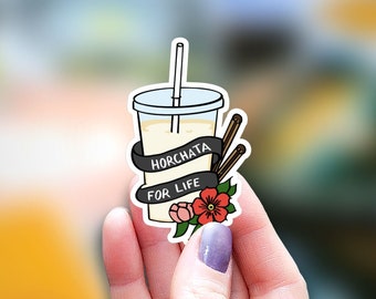 May include: A sticker of a glass of horchata with a straw, cinnamon sticks, and a flower. The sticker has the text "Horchata for Life" on it.