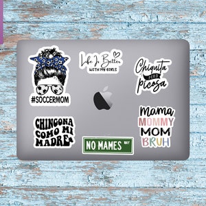 May include: A set of six colorful vinyl stickers with various phrases and designs. The stickers feature phrases like "#soccermom", "Chingona como mi madre", "Life is better with my girls", "Chiquita pero picosa", "No mames", and "Mama Mommy Mom Bruh".