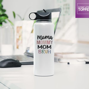 May include: White stainless steel water bottle with a black lid and a carrying handle. The bottle has the text "Mama Mommy Mom  Bruh" printed on it in colorful letters.