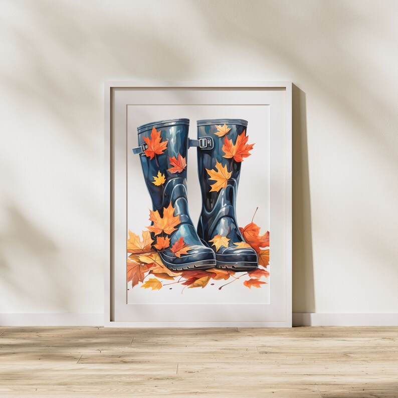 May include: A pair of blue rain boots with orange and yellow leaves on them. The boots are sitting on a white background.