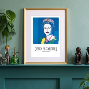 May include: A framed print of a pop art portrait of Queen Elizabeth II by Andy Warhol. The portrait is in a blue, yellow, and pink color scheme. The print is hanging on a teal wall above a mantelpiece.