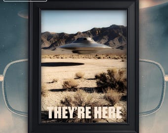 May include: Framed print featuring a desert landscape with a metallic flying saucer hovering above. The text "THEY'RE HERE" is displayed prominently. The frame is black, with the word "NEW" in the upper left corner and "PREMIUM FRAMES" at the bottom.