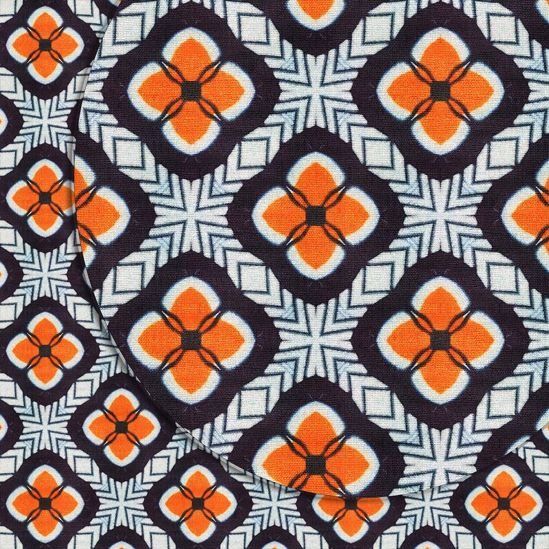 May include: A repeating pattern of orange and white flowers on a dark blue background. The pattern is made up of four-petal flowers with a black center. The flowers are arranged in a grid pattern.