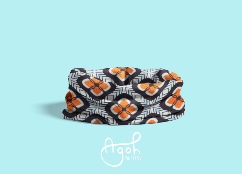 May include: A black, white, and orange patterned neck gaiter. The pattern features geometric shapes and a repeating design.