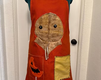 Avental de cozinha de Halloween com bolsos, inspirado em Sam Trick or Treat.