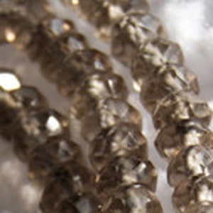 May include: A strand of clear glass beads with a faceted, star-shaped design.