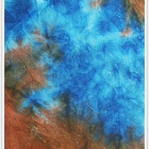 May include: Abstract tie-dye fabric with blue, brown, and black colors. The fabric has a textured, wrinkled appearance.