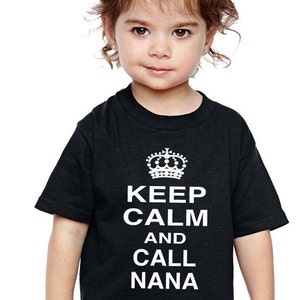 May include: A black t-shirt with a white crown and the text "Keep Calm and Call Nana" printed on the front.