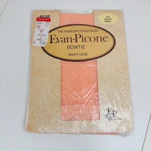 May include: A package of Evan-Picone Bowtie pantyhose in blush pink. The packaging features a gold and white chevron pattern and the text "The Fashion Collection." The pantyhose are small size.