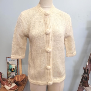 May include: A set of three ceramic mugs with a speckled, matte finish. Each mug features a different color: light blue, cream, and gray. The mugs have a simple, modern design and a comfortable handle.