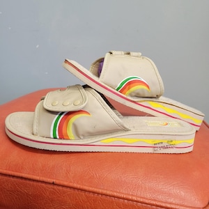 May include: A set of three ceramic mugs with a speckled, matte finish. The mugs are in shades of cream, light brown, and dark brown. Each mug has a simple, minimalist design, perfect for coffee or tea.