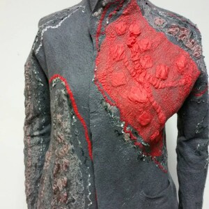 May include: A gray wool jacket with a red, pink, and gray patterned design. The jacket has a collar and long sleeves.