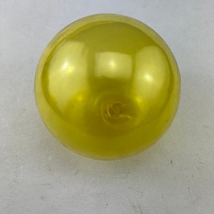 May include: A shiny, yellow balloon.