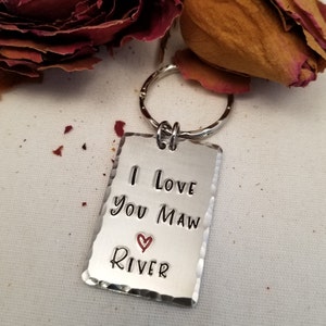 May include: Silver keychain with a rectangular tag that reads "I love you Maw River" with a red heart symbol.