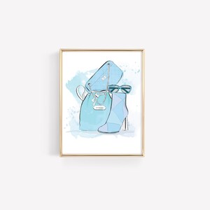 May include: A framed illustration of a blue handbag, blue boots, and blue sunglasses on a watercolor background.