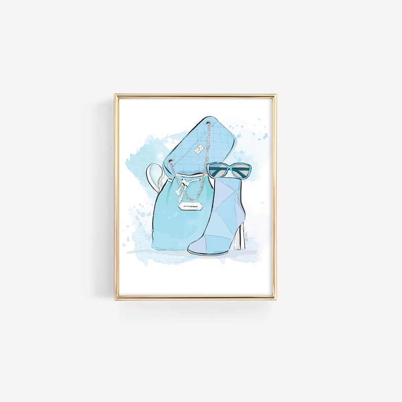 May include: A framed illustration of a blue handbag, blue boots, and blue sunglasses on a watercolor background.