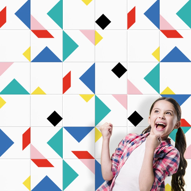 May include: White square tiles with a colorful geometric pattern of triangles, diamonds, and other shapes in red, blue, yellow, pink, and teal. A young person is smiling and looking up at the tiles.