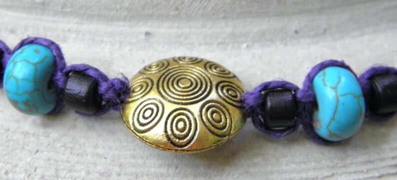 Hemp necklace in purple with brass turquoise and wood beads