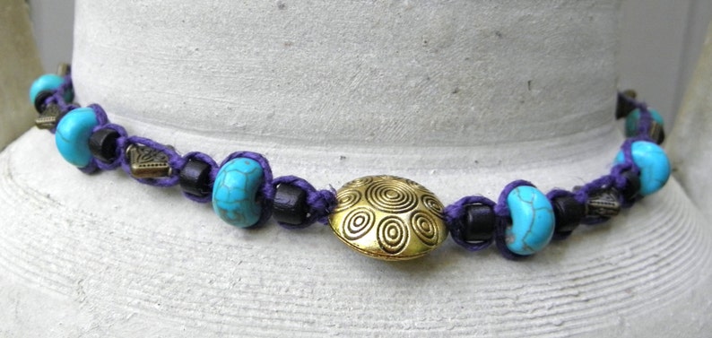 Hemp necklace in purple with brass turquoise and wood beads