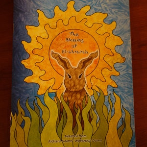 May include: A book cover with a yellow sun and a brown rabbit in the center. The title is "The Blessing of El-ahrairah" and the text "Adapted from Richard Adams' Watership Down" is at the bottom.