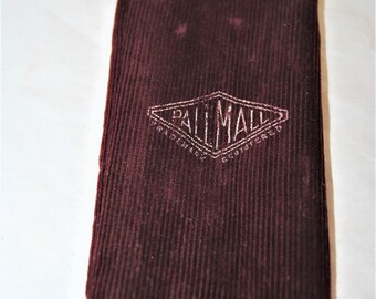 May include: A burgundy corduroy pouch with a white diamond-shaped label that reads "Dall Mall Trademark Registered".