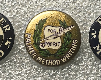 May include: Three round, blue and gold, vintage buttons with the text "Palmer Method" and a hand holding a pen. The gold button has a scroll with the text "For Merit" inside a wreath.