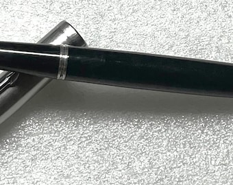 May include: A black and green fountain pen with a silver cap and a black nib.