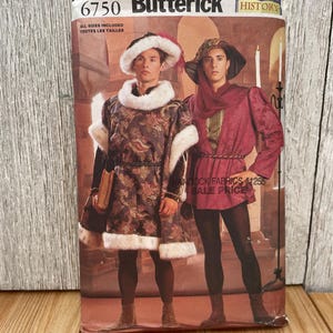 May include: A Butterick 6750 sewing pattern envelope featuring historical costumes. One outfit includes a patterned tunic with white faux fur trim and a matching hat. The second outfit features a solid magenta tunic with a hood, dark leggings, and boots.