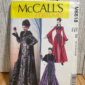 May include: A McCall's Costumes sewing pattern, M6818, featuring illustrations of three different costume designs. The costumes include long coats and capes in black, red, and purple. The pattern size is D5 (12-14-16-18-20).