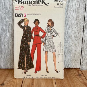May include: Vintage Butterick sewing pattern 6878 featuring three fashion illustrations. The pattern includes a size 12 1/2 with a bust measurement of 35 inches. The cover displays a floral print dress, a red pantsuit, and a polka dot dress.