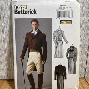 May include: Butterick B6573 sewing pattern for historical men's clothing. The pattern includes a double-breasted coat, breeches, and a long coat. The package features a color image of a man in a brown coat and breeches.