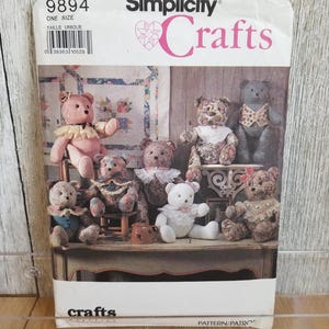 May include: Simplicity Crafts pattern featuring various teddy bear designs. The cover displays multiple plush bears with different outfits and styles, including a pink bear with a ruffled collar. The text "Crafts" is prominently displayed.
