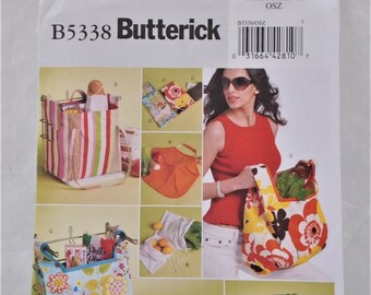 May include: A sewing pattern for making reusable shopping bags. The pattern includes five different designs, including a striped bag, a floral bag, and a bag with a pocket. The pattern is from Butterick and has the number B5338 on it.