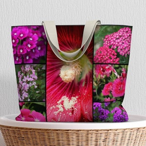 May include: A pink and purple floral tote bag with a collage of different flowers. The bag has a canvas material and two fabric handles.