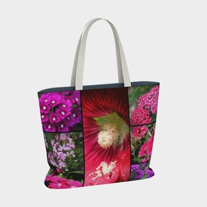 May include: A tote bag with a collage of pink, purple, and red flowers. The bag has white straps and a dark blue lining.