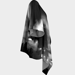 May include: Black and white kimono with a cloud and tree design. The kimono is made of a soft, flowing fabric and has a relaxed fit.
