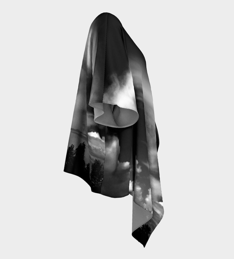 May include: Black and white kimono with a cloud and tree design. The kimono is made of a soft, flowing fabric and has a relaxed fit.