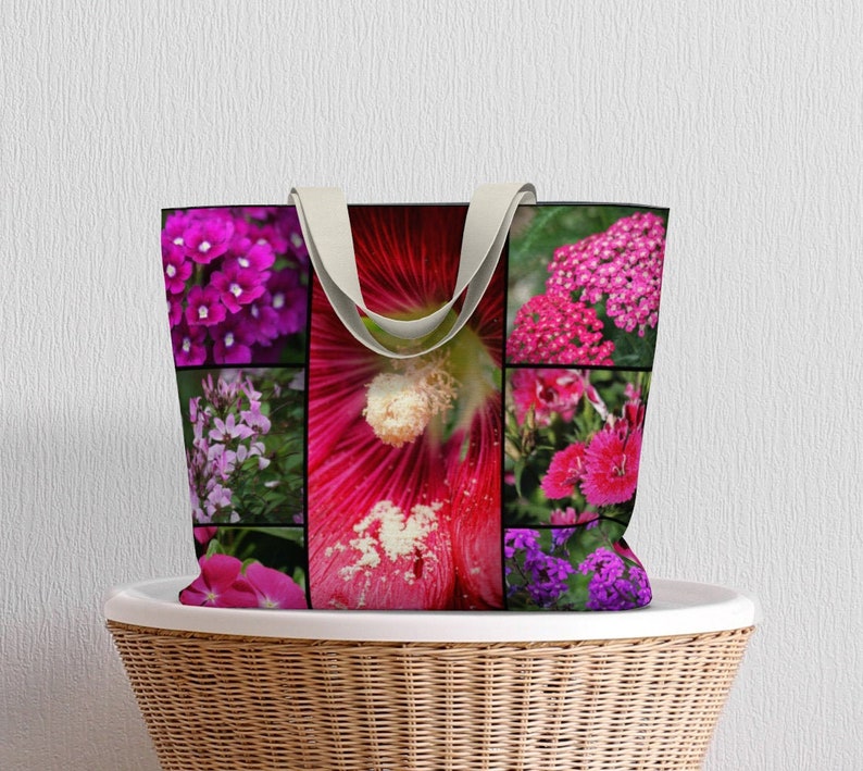 May include: A pink and purple floral tote bag with a collage of different flowers. The bag has a canvas material and two fabric handles.
