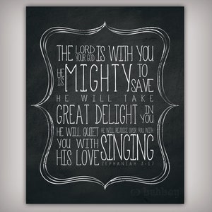 May include: Black and white typography on a black chalkboard background with the text "The Lord is with you, your God is mighty to save. He will take great delight in you with his love singing. Zephaniah 3:17"
