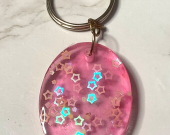 Pink oval keychain with iridescent stars, handmade resin