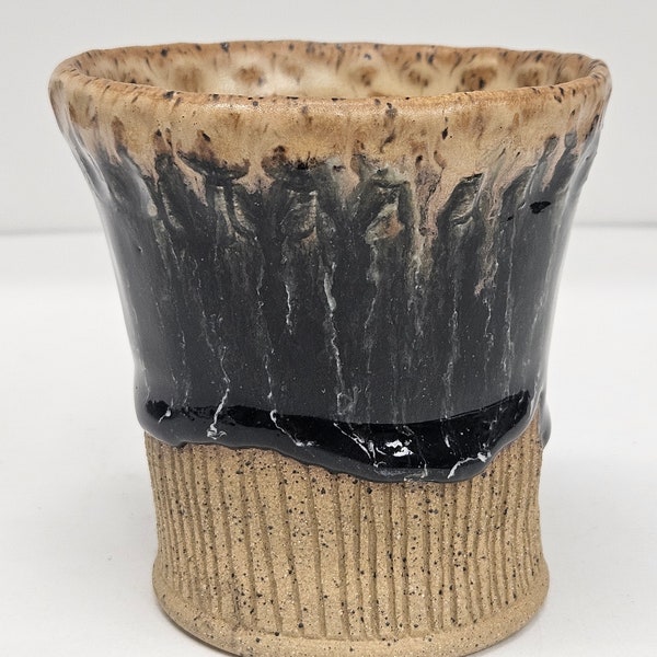 Ceramic cup, speckled buff clay with black and white glazes