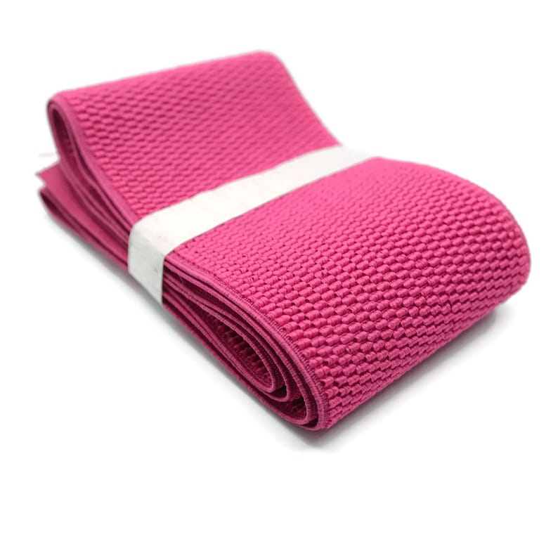 May include: Pink elastic band with a textured surface. The band is folded and rolled up.