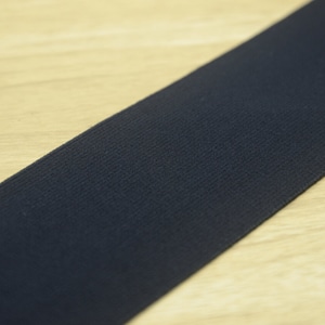 May include: A close-up of a black elastic band. The band is made of a soft, stretchy material and has a smooth, even texture.