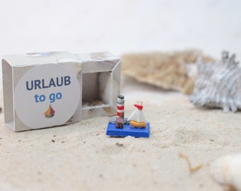 Holiday to go, travel for your pocket, holiday to go, lighthouse miniature, small sailing boat, holiday decoration