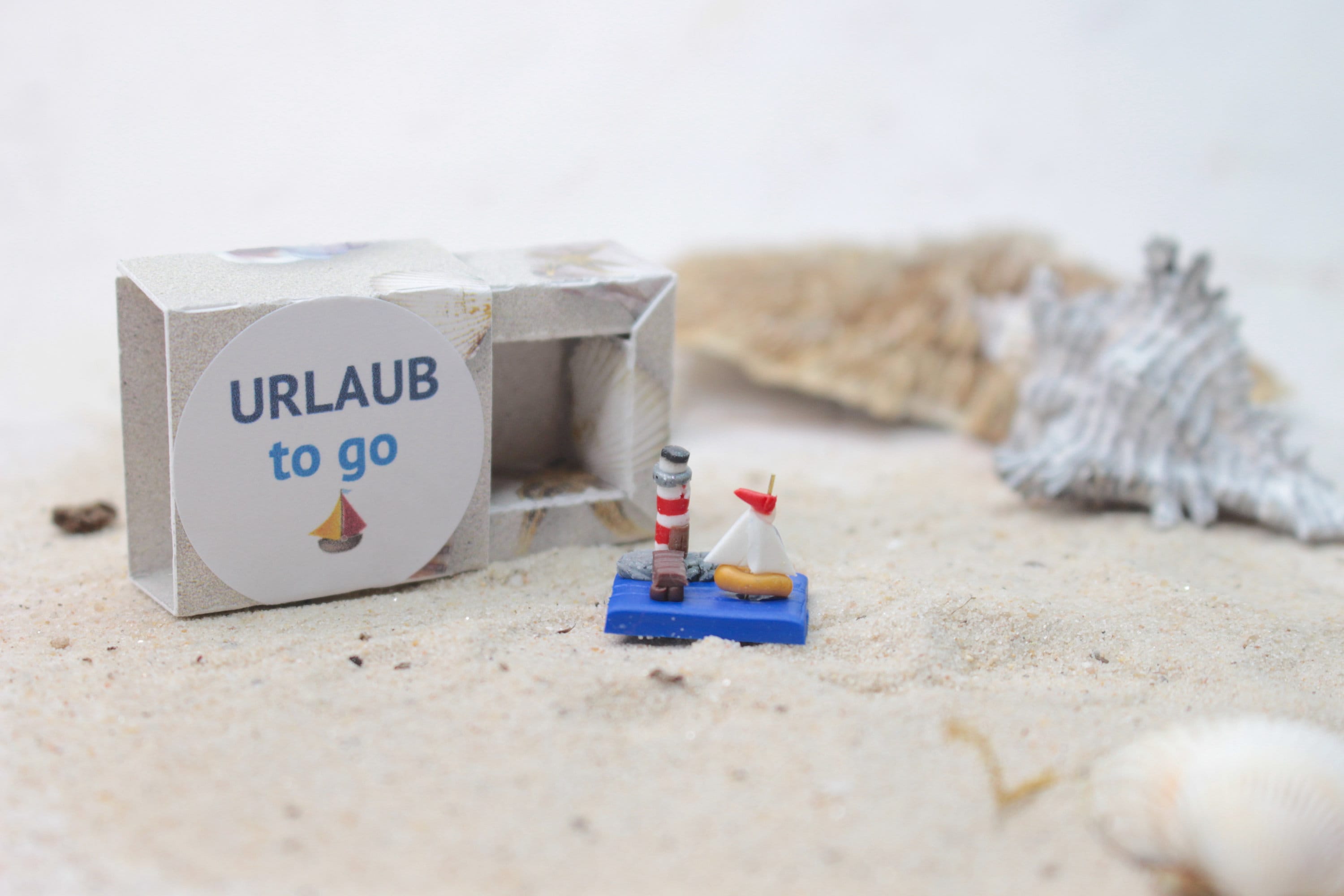 Holiday to go, travel for your pocket, holiday to go, lighthouse miniature, small sailboat, holiday decoration