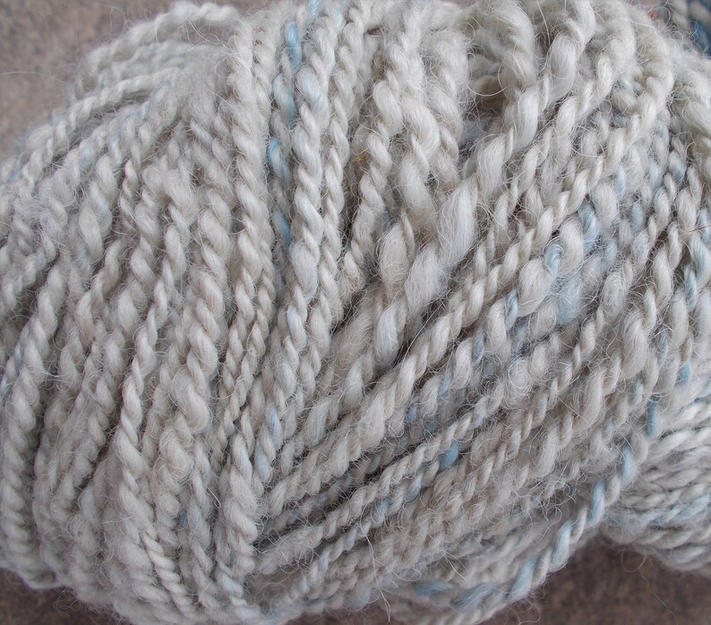2ply 142 yds Handspun silvergrey alpaca yarn with a touch of hand dyed sky blue angora