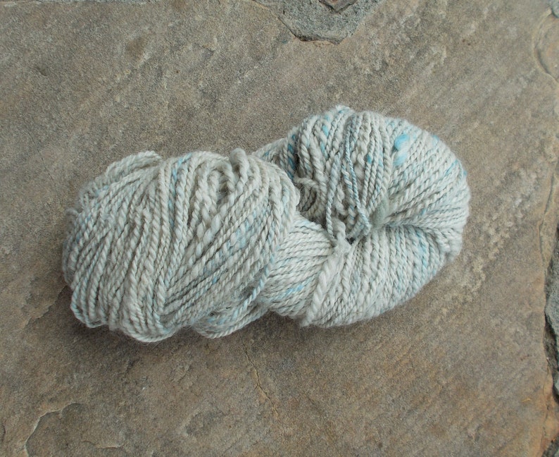 2ply 142 yds Handspun silvergrey alpaca yarn with a touch of hand dyed sky blue angora