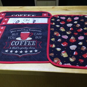 May include: Set of four black and red coffee-themed placemats. One placemat features a red coffee cup with white polka dots and the text "You can't buy happiness but you can buy coffee & that's pretty close". Another placemat features the word "COFFEE" in white text. The remaining two placemats feature a repeating pattern of coffee cups and coffee beans.